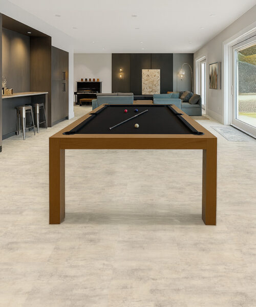 Ivory Concrete Swiss Linodesign Floating Flooring In A Spacious Basement Recreation Room, Highlighting Its Waterproof, Durable, And Modern Concrete-Look Surface.