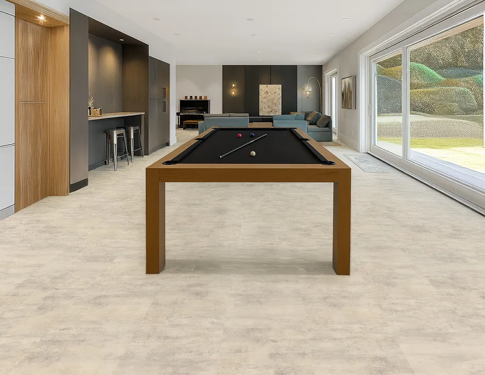 Ivory Concrete Swiss Linodesign Floating Flooring In A Spacious Basement Recreation Room, Highlighting Its Waterproof, Durable, And Modern Concrete-Look Surface.