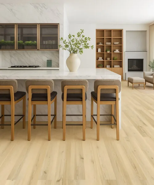 Open kitchen and dining area with Lucerne Glow Pinewood Swiss Design cork flooring in a natural blonde hue and modern interior style.