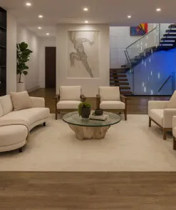 Contemporary family room featuring Latte Swiss cork floating flooring, curved sofa, soft beige chairs, and wood accent wall.