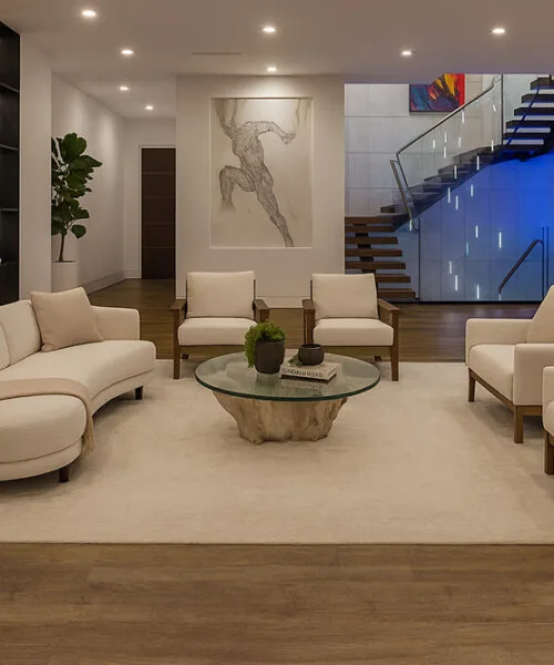 Latte - 7/16&Quot; (11Mm) - Swiss Design Cork Floating (Flat11) Contemporary Family Room Featuring Latte Swiss Cork Floating Flooring, Curved Sofa, Soft Beige Chairs, And Wood Accent Wall.