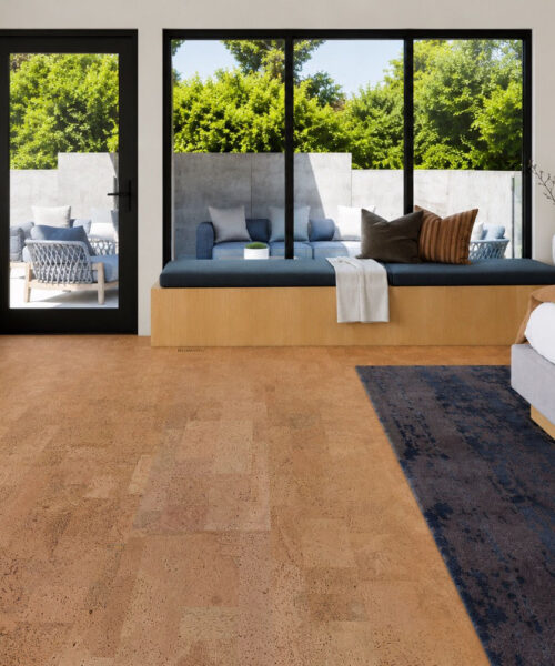 Leather Natural 12mm cork floating flooring in a modern bedroom with a window seat, black framed windows, and warm natural cork floors.
