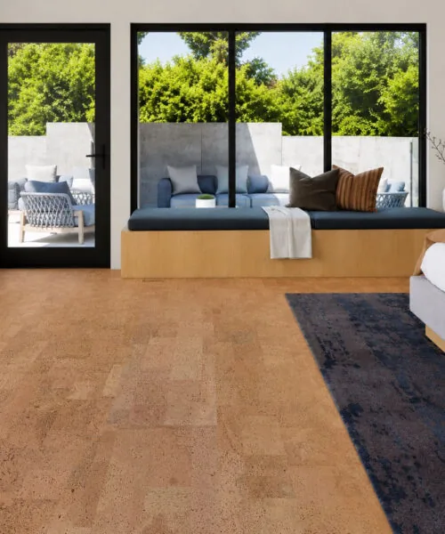 Leather Natural 12mm cork floating flooring in a modern bedroom with a window seat, black framed windows, and warm natural cork floors.
