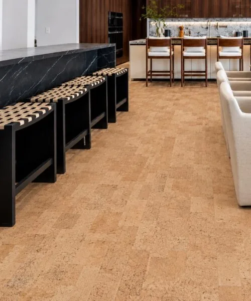 Leather - 1/4&Quot; (6Mm) - Cork Glue Down Tile (Gle6) Leather Natural 12Mm Cork Floating Flooring In A Luxury Kitchen With Black Marble Island, Wood Cabinetry, And Bar Seating.