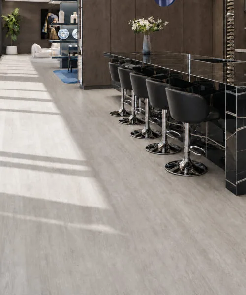 Light Grey Oak - 13/32&Quot; (10.5Mm) - Design Cork Floating (Flg10.5) Light Grey Oak Cork Flooring In A Modern Kitchen With A Black Marble Island And Bar Seating