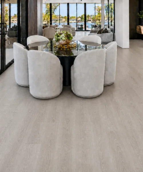 Light Grey Oak - 13/32&Quot; (10.5Mm) - Design Cork Floating (Flg10.5) Light Grey Oak Plank Flooring In A Waterfront Dining Room With Glass Doors And White Chairs