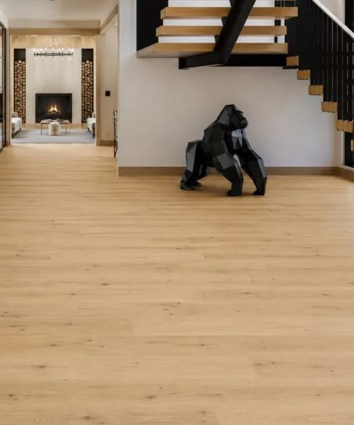 Modern Entryway Featuring Long Beach 11Mm Swiss Design Cork Floating Flooring In A Light Natural Oak Finish With An Open Staircase And Contemporary Architecture.