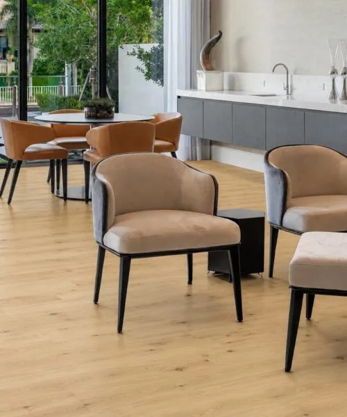Modern Lounge And Dining Area Showcasing Long Beach Swiss Design Cork Flooring With Light Oak Planks, Large Windows, And Luxury Seating.