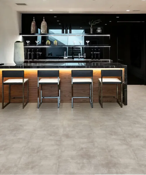 Minimalist modern kitchen with Copperstone Gray Forna Natural Composite waterproof flooring and matte black island