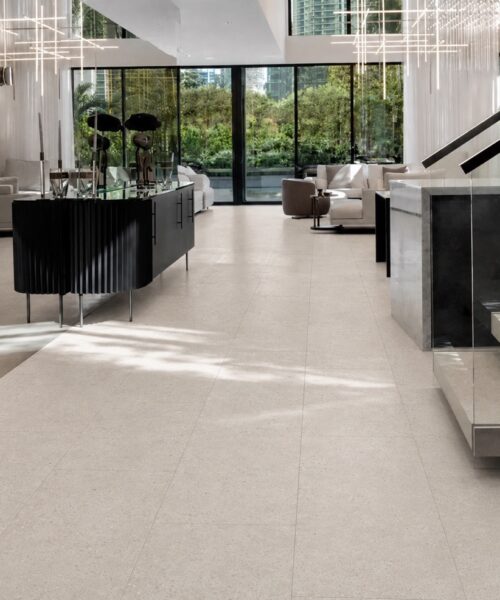 Matera Blend - 19/64&Quot; (7.5Mm) - Swiss Techslate (Mmatbd7.5) Light Limestone Matera Blend Click-Lock Flooring Runs In Staggered Rectangular Planks Through A Contemporary Entryway And Living Room.