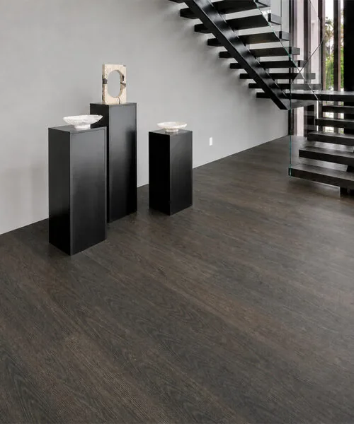 Mocha dark brown floating cork flooring in a traditional hallway with a staircase and French doors.