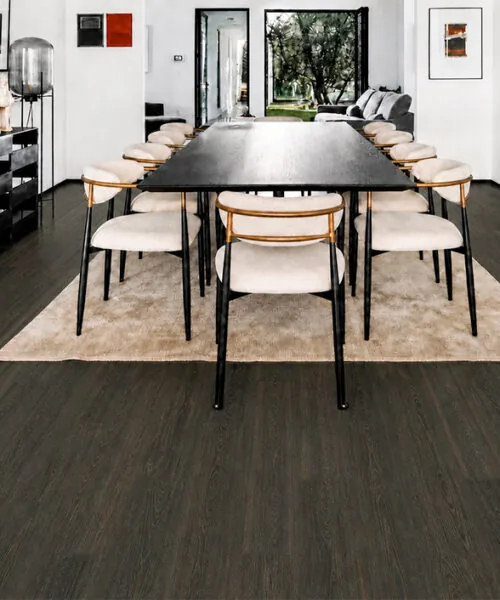 Mocha - 7/16&Quot; (11Mm) - Swiss Design Cork Floating (Fmoc11) Mocha Dark Brown Cork Floating Flooring In A Modern Dining Room With A Long Table And Artwork.