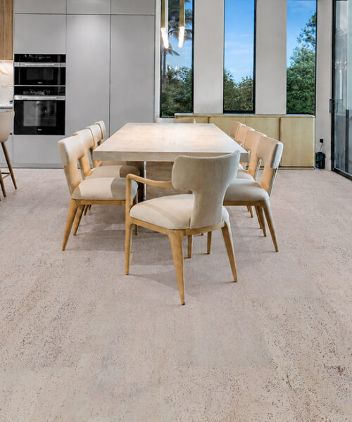 Mystic Vanilla Swiss Real Cork Floating Flooring With Pale Speckled Planks In A Modern Kitchen And Dining Room.