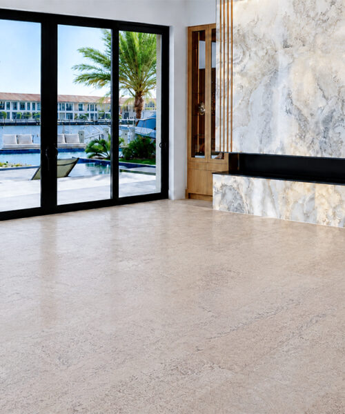 Mystic Vanilla Swiss Real Cork Floating Flooring In A Waterfront Entryway With Glass Doors And A Marble Feature Wall.