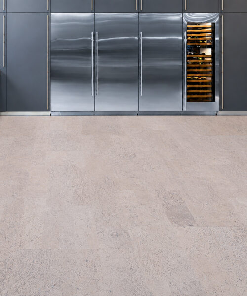Mystic Vanilla Swiss Real Cork Floating Flooring With Light Beige Cork Planks In A Kitchen With Dark Cabinetry.