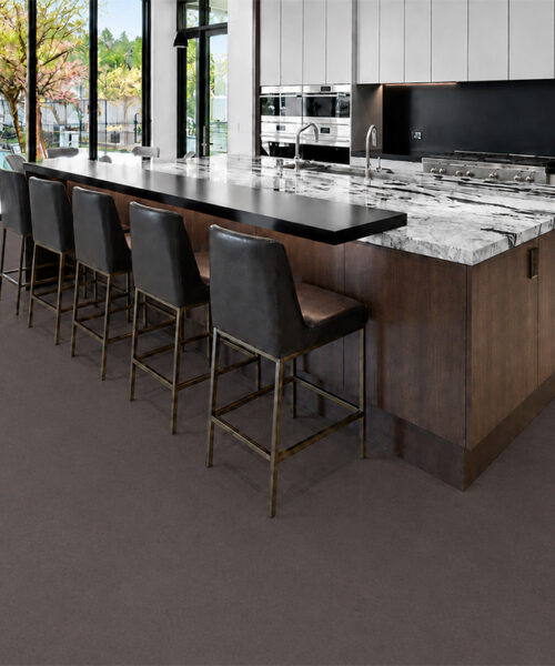 Night - 7/16&Quot; (11Mm) - Swiss Real Cork Floating (Fnig11) Night Black Cork Floor Planks Surround A Marble Island And Dark Bar Stools In A Contemporary Kitchen.