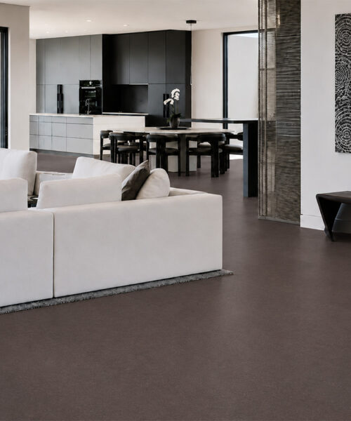 Night - 7/16&Quot; (11Mm) - Swiss Real Cork Floating (Fnig11) Night Cork Flooring For A Living Room Surrounds Curved Sofas And Black Tables Overlooking The Waterfront.