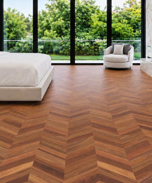 Noble Chevron Walnut Cork Floor Planks Surround A White Bed And Marble Fireplace In A Garden-View Bedroom.