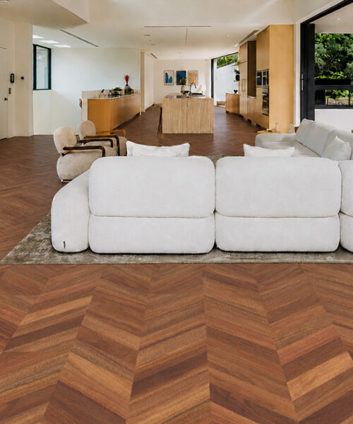 Noble Chevron Floating Cork Flooring Flows Across An Open-Plan Living Room With White Sofas And A Wood Kitchen.