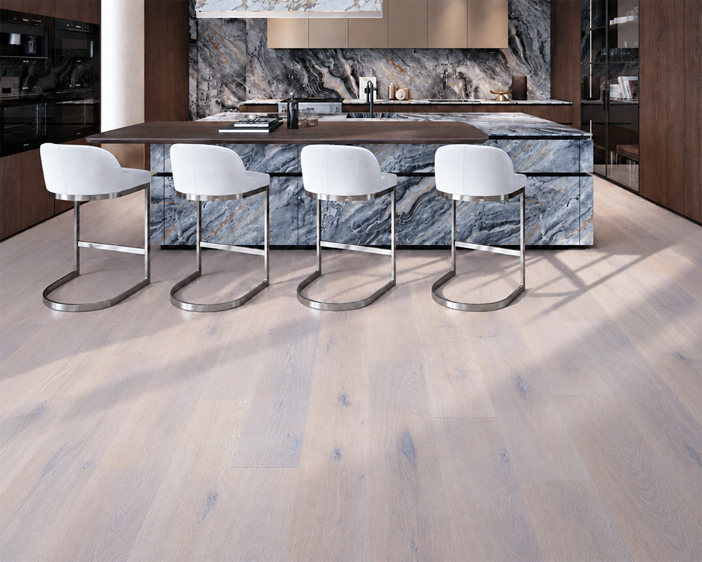 Nordic Oak - 3/8&Quot; (9.5Mm) - Forna Natural Composite Flooring With Waterproof Hydrowood Core (Nnoro9.5) Nordic Oak Pale Gray Wood-Look Natural Composite Flooring Surrounds A Marble Kitchen Island With White Bar Stools.