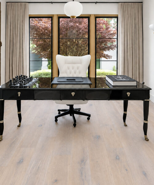 Nordic Oak - 3/8&Quot; (9.5Mm) - Forna Natural Composite Flooring With Waterproof Hydrowood Core (Nnoro9.5) Nordic Oak Swiss-Made Natural Composite Flooring Displays White-Gray Oak Grain Beneath A Black Desk In A Textured-Wall Office.