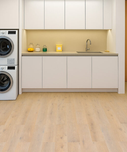 Nordic Oak Swiss Linoleum Floor In A Bright Laundry Room With White Cabinets And Stacked Machines.
