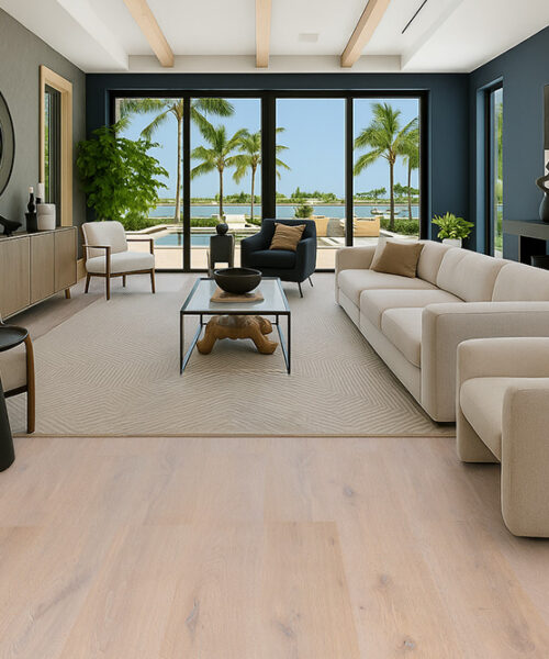 Luxurious living room showcasing Nordic Oak Swiss Real Linoleum Floating Flooring in soft natural oak color, paired with modern beige furniture and large windows overlooking a pool and palm trees.