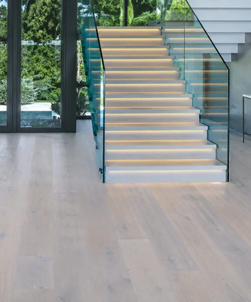 Nordic Oak - 3/8&Quot; (9.5Mm) - Forna Natural Composite Flooring With Waterproof Hydrowood Core (Nnoro9.5) Nordic Oak Natural Composite Flooring In A Modern Entryway With A Glass Staircase And Large Windows