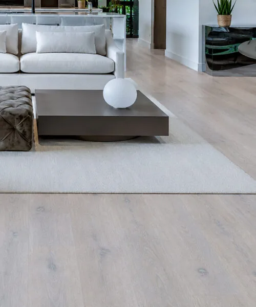 Nordic Oak Forna Natural Composite flooring in a bright modern living room with wide pale oak planks