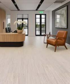 Professional office reception with light wood desk, leather chair, and Vertical Swiss cork flooring, highlighting modern design and acoustic comfort.