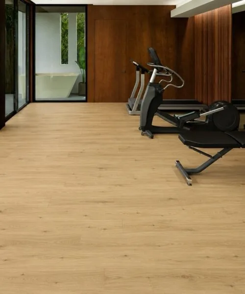 Contemporary Home Gym With Long Beach Swiss Design Cork Floating Flooring In A Natural Light Oak Finish And Premium Fitness Equipment.