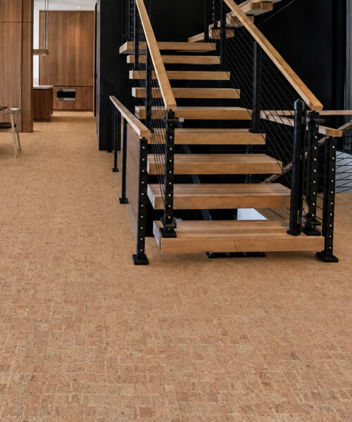 ParCork Swiss Real Cork flooring in warm staggered planks around a modern open staircase.