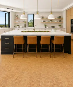 Bright modern kitchen with center island and bar stools set on Quodro Swiss cork flooring in honey-beige tones.