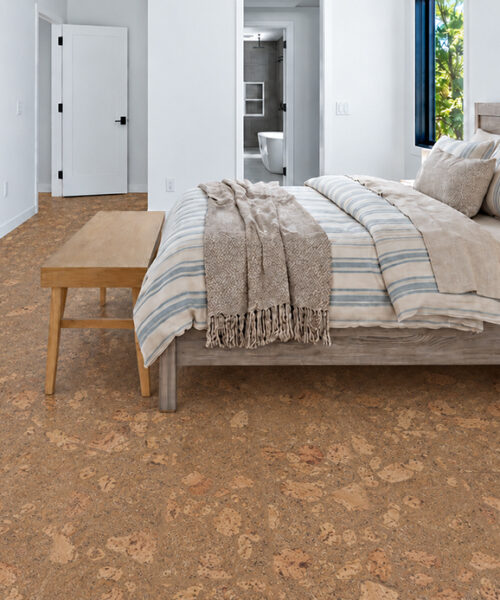 Rococo - 1/2&Quot; (12Mm) - Cork Floating (Froco12) Rococo Warm Amber Floating Cork Flooring With Marble-Like Pattern Surrounds A Wood Bed And Bench.