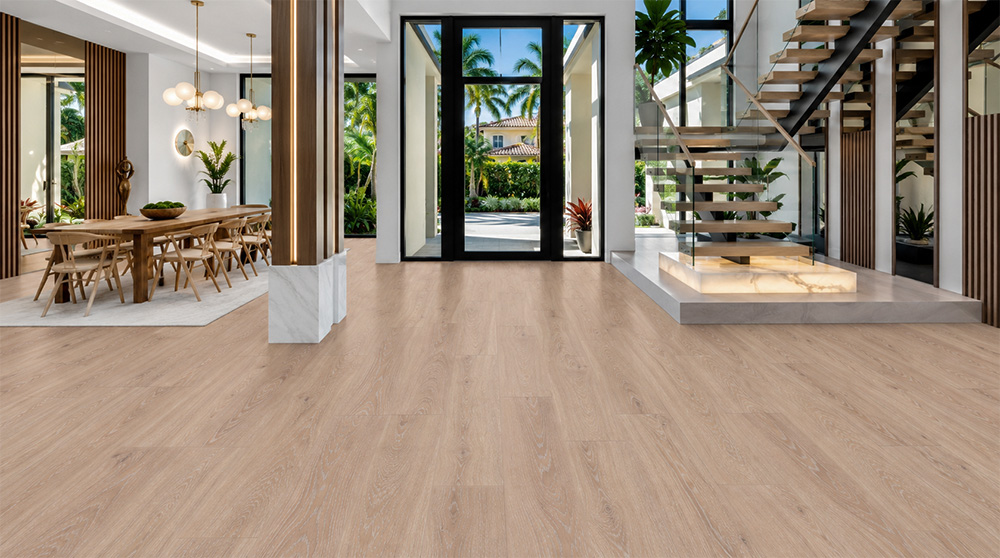 Sandstorm - 7/16&Quot; (11Mm) - Swiss Design Cork Floating (Fsan11) Sustainable Sandstorm Hardwood-Look Cork Flooring In An Open Modern Entryway With Tropical Views, An Adjacent Dining Area, And Glass Staircase.