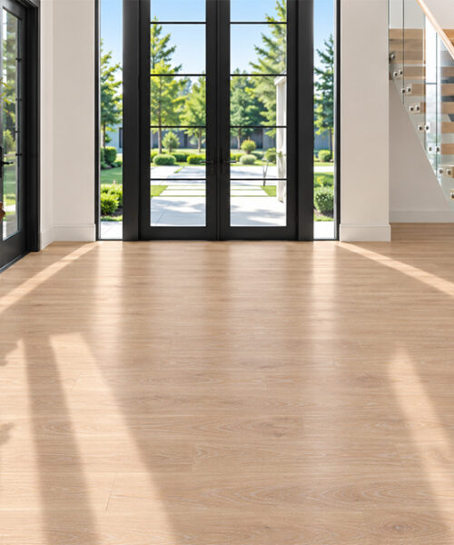 Usa'S Best Cork Flooring, Wall Tiles, Underlayment And More Sustainable Sandstorm Wood-Grain Cork Flooring In A Sunlit Modern Entryway With Black-Framed Doors, A Glass Staircase, And Sculptural Wood Console.