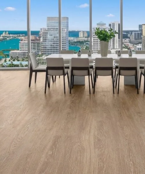 Sandstorm Swiss Design Cork Floating Flooring In A Luxury Dining Room With Panoramic City Views, Light Oak Wood Grain, And Floor-To-Ceiling Windows.