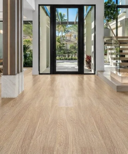Sandstorm Swiss Design cork floating flooring in a modern entryway featuring a floating staircase, light oak wood grain, and open-concept luxury interior.