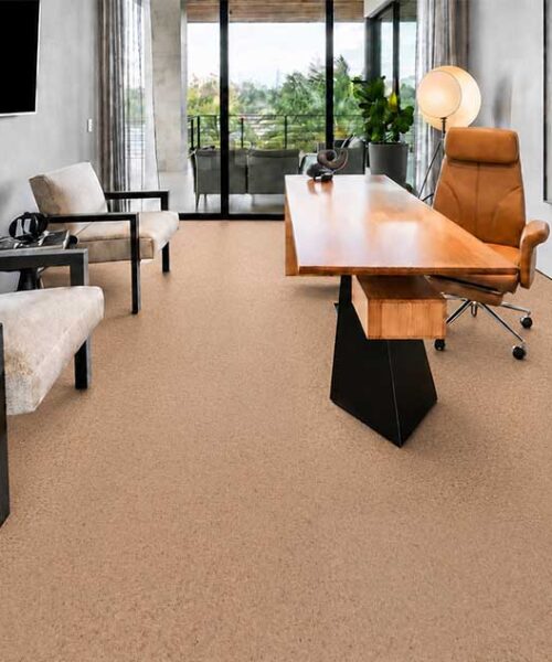 Seaside cork flooring for an office surrounds a wood desk and upholstered guest chairs.