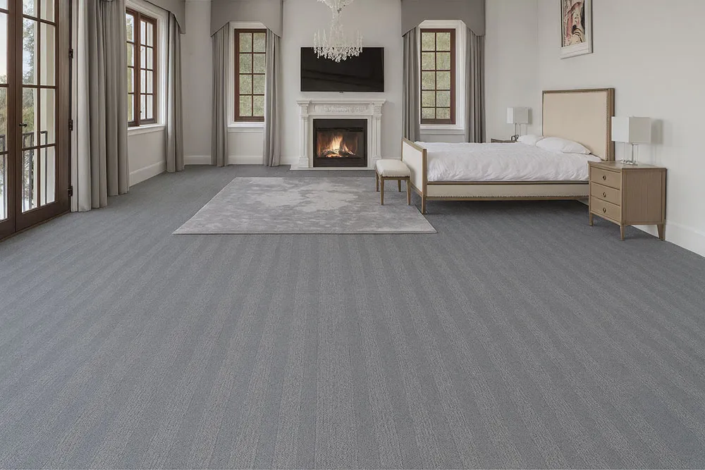 Elegant Bedroom With Serpent Luxe Forna Swiss Leather Floating Flooring, Gray Patterned Design Adding Modern Luxury Under A Cozy Fireplace Setting.
