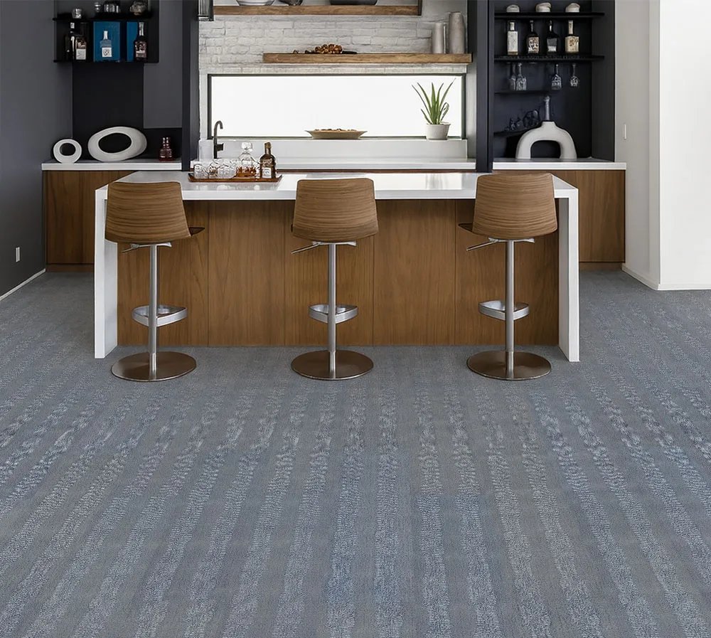 Contemporary Kitchen Bar With Serpent Luxe Forna Swiss Leather Flooring, Textured Gray-Blue Floating Planks Enhancing Wood Cabinetry And Modern Stools