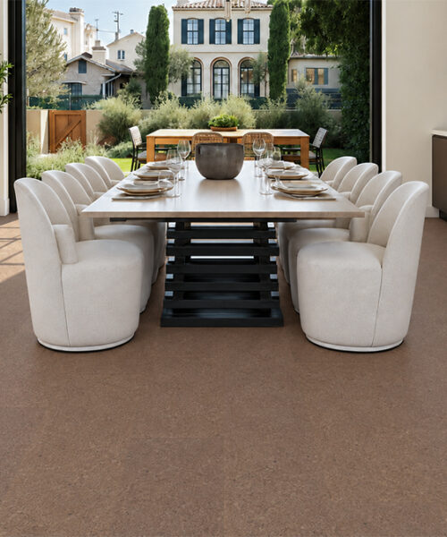 Shoreline 10mm natural mid-brown floating cork flooring anchors a bright dining room with garden doors.