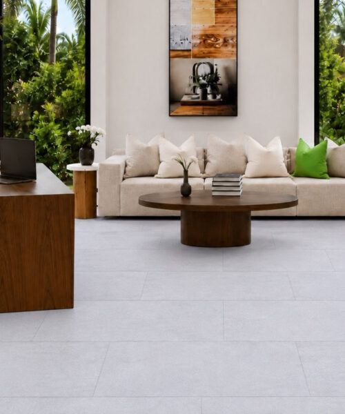 Snowstone - 19/64&Quot; (7.5Mm) - Swiss Techslate (Mcsnows7.5) Snowstone Eco-Friendly Flooring In A Pale Gray Concrete-Look Design Complements A Home Office With A Wood Desk And Sofa.