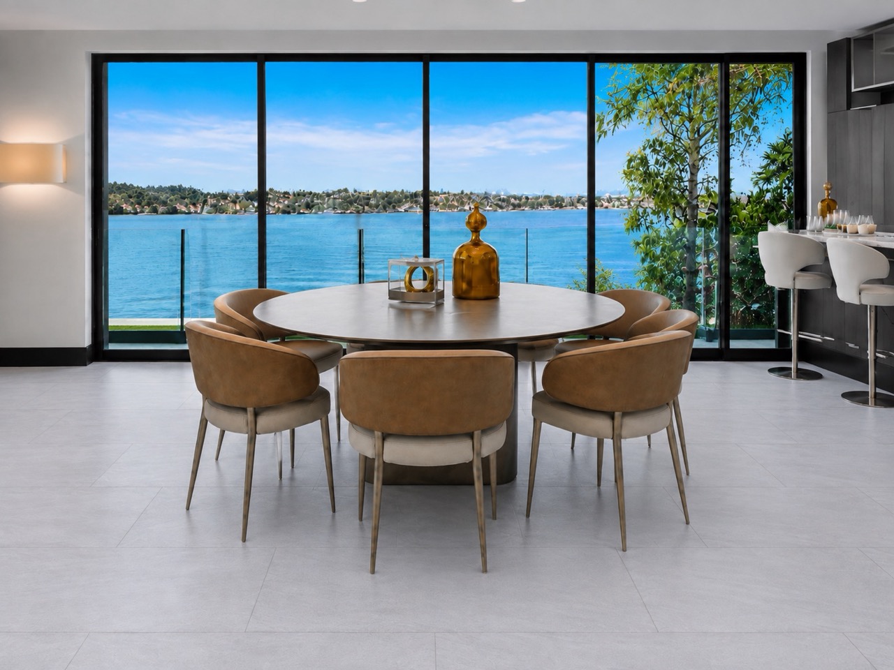 Snowstone - 19/64&Quot; (7.5Mm) - Swiss Techslate (Mcsnows7.5) Pale Gray Snowstone Stone-Look Flooring Creates A Modern Dining Room With A Round Table, Leather Chairs, And Expansive Waterfront Windows.
