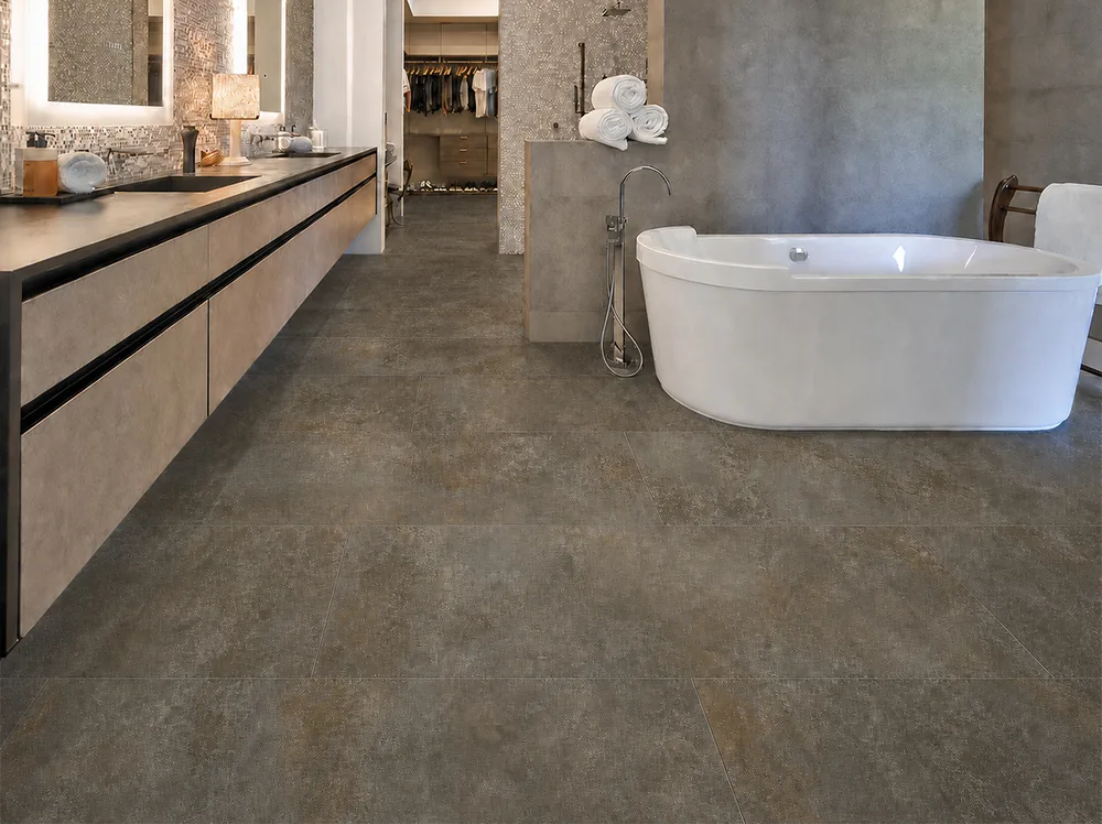 Sunlit Stone - 19/64&Quot; (7.5Mm) - Swiss Techslate (Msunst7.5) Sunlit Stone Swiss Techslate Brown-Gray Stone-Look Flooring In A Luxury Bathroom With A Freestanding Bathtub.
