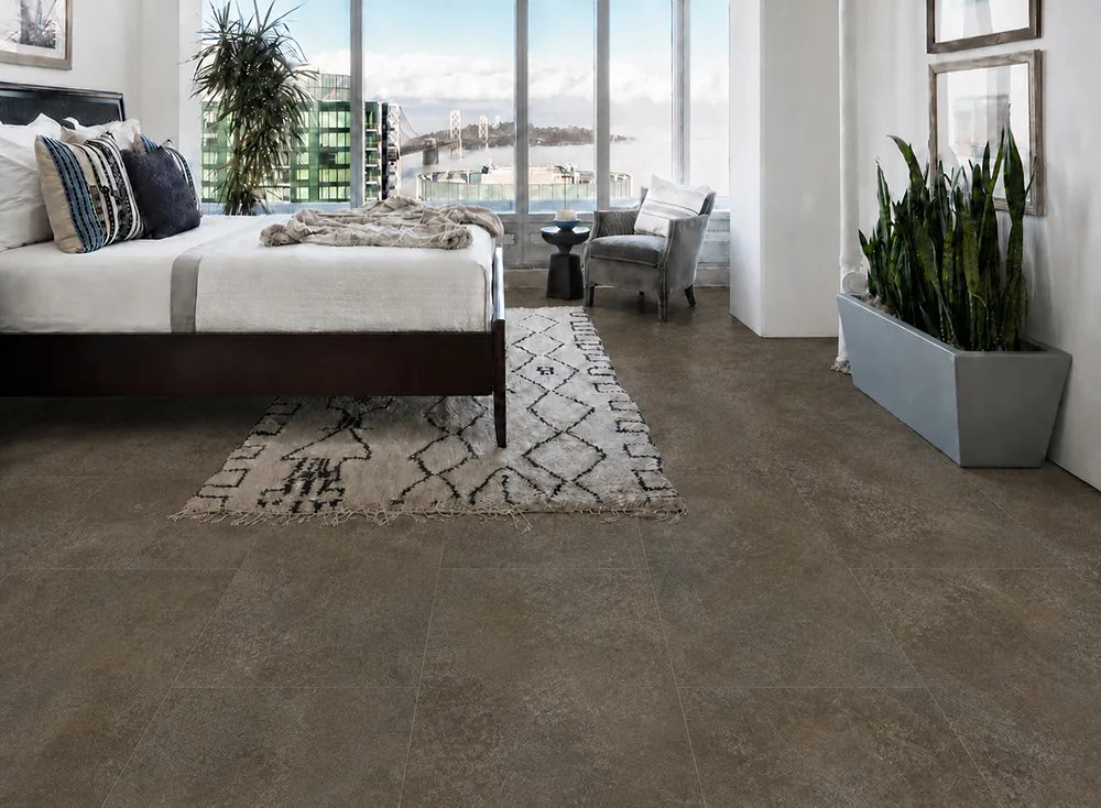Sunlit Stone - 19/64&Quot; (7.5Mm) - Swiss Techslate (Msunst7.5) Sunlit Stone Brown-Gray Stone-Look Flooring In A Modern Bedroom With Floor-To-Ceiling Windows