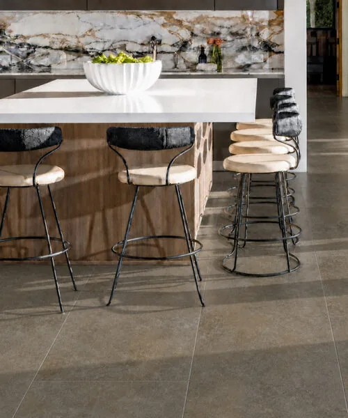 Sunlit Stone brown-gray Swiss Techslate flooring in an open-concept kitchen and dining room.