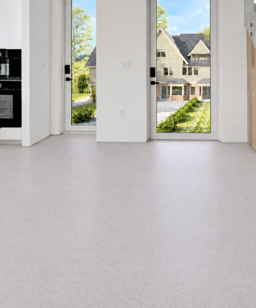 Sustainazzo White Speckled Cork Floor Planks Brighten A Modern Entryway Beside A Glass-Railed Staircase.