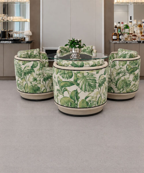 Sustainazzo White Terrazzo-Inspired Cork Flooring Beneath Botanical Chairs And A Glass Table In A Home Bar.