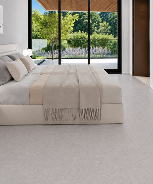 Sustainazzo Terrazzo-Look Cork Floor Planks Create A Light Neutral Surface In A Minimalist Garden-View Bedroom.